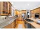 Light-filled kitchen boasts granite countertops, stainless steel appliances, and a spacious island with seating at 85 Willowleaf Dr, Littleton, CO 80127