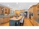 Spacious kitchen features a central island with gas cooktop and seating, and stainless steel appliances at 85 Willowleaf Dr, Littleton, CO 80127