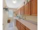 Functional laundry room with ample cabinet space, a utility sink, and a washer and dryer at 85 Willowleaf Dr, Littleton, CO 80127