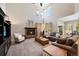 Bright, open living room with fireplace, soaring ceilings, and ample seating for entertaining at 85 Willowleaf Dr, Littleton, CO 80127