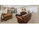 Cozy living room with built-in shelving and comfortable seating in a finished basement at 85 Willowleaf Dr, Littleton, CO 80127