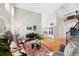 Bright and airy living room with vaulted ceilings, hardwood floors, and a staircase at 85 Willowleaf Dr, Littleton, CO 80127