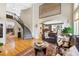 Elegant living room showcasing a staircase, arched doorway, and fireplace beyond at 85 Willowleaf Dr, Littleton, CO 80127