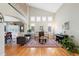Spacious living room with large windows, hardwood flooring, and comfortable seating area at 85 Willowleaf Dr, Littleton, CO 80127