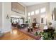 Cozy living room featuring hardwood floors, large windows, and a view into the dining room at 85 Willowleaf Dr, Littleton, CO 80127