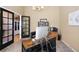 Another view of the home office, highlighting black french doors and a modern desk setup at 85 Willowleaf Dr, Littleton, CO 80127