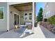 Covered patio with outdoor seating, grill, and a view of the landscaped yard at 85 Willowleaf Dr, Littleton, CO 80127