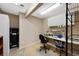 Functional work area with ample storage, and a workbench with a rolling office chair at 85 Willowleaf Dr, Littleton, CO 80127