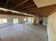 Unfinished basement featuring exposed beams and a sliding glass door to the backyard at 10178 Hutch Ln, Conifer, CO 80433