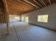 Unfinished basement featuring exposed beams and a sliding glass door to the backyard at 10178 Hutch Ln, Conifer, CO 80433