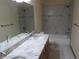 Elegant bathroom featuring double vanity, granite countertop, tiled walls, and a shower-tub combination at 10178 Hutch Ln, Conifer, CO 80433