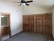 Bedroom featuring plush carpet, ceiling fan, wood trim, closet with doors, and an ensuite bath at 10178 Hutch Ln, Conifer, CO 80433