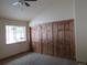 Comfortable bedroom features carpeted floors, a window with outdoor views, and a barn-door style closet at 10178 Hutch Ln, Conifer, CO 80433