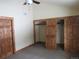Bright bedroom showcases carpeted floors, ceiling fan, and a unique sliding barn-door closet at 10178 Hutch Ln, Conifer, CO 80433