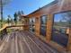 A home's deck featuring wood flooring, iron railings, and views of mountains and lush trees at 10178 Hutch Ln, Conifer, CO 80433