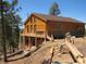 Newly constructed home boasts wood siding and a large deck, perfect for enjoying the surrounding nature at 10178 Hutch Ln, Conifer, CO 80433