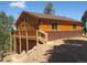 Charming wood home featuring a spacious deck, offering great outdoor living and mountain views at 10178 Hutch Ln, Conifer, CO 80433