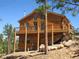 Attractive wood home with an expansive deck, perfect for enjoying the surrounding nature and scenery at 10178 Hutch Ln, Conifer, CO 80433