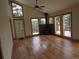 Spacious living room featuring wood floors, a fireplace, multiple windows and exterior deck access at 10178 Hutch Ln, Conifer, CO 80433
