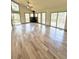 Open living area with wood floors, a stone fireplace, many windows and access to a wooden deck at 10178 Hutch Ln, Conifer, CO 80433