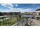 A charming balcony with wrought iron railing overlooking lush greenery and neighborhood, perfect for enjoying the outdoors at 924 Brookhurst Ave # C, Highlands Ranch, CO 80129
