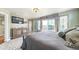 Bedroom with dark wood furniture, decorative windows, and access to a balcony at 924 Brookhurst Ave # C, Highlands Ranch, CO 80129
