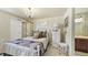 A cozy bedroom with a chandelier, large bed, carpeted floors and decorative closet, creating a serene retreat at 924 Brookhurst Ave # C, Highlands Ranch, CO 80129