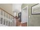 View of hallway with hardwood floors, staircase, and open doorway leading to the living room at 924 Brookhurst Ave # C, Highlands Ranch, CO 80129