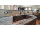 Close-up on a copper sink with a tile backsplash and granite countertops at 924 Brookhurst Ave # C, Highlands Ranch, CO 80129