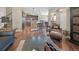 Open-concept living room featuring hardwood floors, kitchen with breakfast bar, and staircase at 924 Brookhurst Ave # C, Highlands Ranch, CO 80129