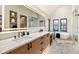 This modern bathroom features double sinks, marble countertops, and a standalone tub for a luxurious and relaxing experience at 224 S Ridge St, Breckenridge, CO 80424