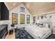 Stunning primary bedroom with vaulted ceilings, a cozy fireplace, a sitting area, and mountain views from multiple windows at 224 S Ridge St, Breckenridge, CO 80424