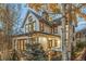 Lovely two-story home featuring a covered porch with Adirondack chairs and beautiful fall foliage at 224 S Ridge St, Breckenridge, CO 80424