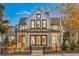 Charming two-story home featuring a black metal fence, a covered porch, and a well-maintained yard at 224 S Ridge St, Breckenridge, CO 80424