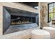 Close-up of a modern linear fireplace with stone surround and unique decorative accents at 224 S Ridge St, Breckenridge, CO 80424