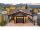 Spacious garage featuring a carriage door, covered parking, mountain views, and exterior lighting at 224 S Ridge St, Breckenridge, CO 80424