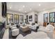 Bright living room featuring a stone fireplace, comfortable seating, and large windows overlooking the yard at 224 S Ridge St, Breckenridge, CO 80424