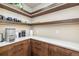 Well-organized pantry featuring sleek cabinetry with white countertops, open shelving, and modern appliances at 224 S Ridge St, Breckenridge, CO 80424