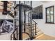 Modern home elevator in a naturally lit stairwell with views of the artwork and outside at 224 S Ridge St, Breckenridge, CO 80424