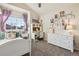 Charming bedroom with a writing desk, white furniture, and ample natural light at 7641 Lebrun Ct, Lone Tree, CO 80124