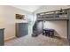 Cozy bedroom featuring a loft bed, complemented by a dresser, desk, and neutral carpet at 7641 Lebrun Ct, Lone Tree, CO 80124