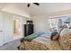 Tranquil bedroom featuring a large window, neutral tones, and access to the bathroom at 7641 Lebrun Ct, Lone Tree, CO 80124