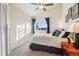 Bright bedroom with a window letting in lots of natural light, a ceiling fan, and carpeted floor at 7641 Lebrun Ct, Lone Tree, CO 80124