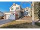 This two-story home with a brick-accented garage boasts curb appeal with tidy landscaping at 7641 Lebrun Ct, Lone Tree, CO 80124