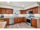 Well-lit kitchen with granite counters, wooden cabinets, and stainless-steel appliances at 7641 Lebrun Ct, Lone Tree, CO 80124