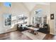 Bright living room with vaulted ceilings and natural light pouring in from large windows at 7641 Lebrun Ct, Lone Tree, CO 80124