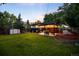 Spacious backyard featuring lush lawn, shed, and covered patio, perfect for outdoor living at 6512 Upham St, Arvada, CO 80003