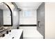 Updated bathroom featuring vertical subway tiles, black trim and a white vanity with gold fixtures at 6512 Upham St, Arvada, CO 80003