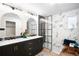 Bright bathroom showcasing a double sink vanity, modern fixtures, and a glass-enclosed shower at 6512 Upham St, Arvada, CO 80003