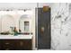 Modern bathroom with double vanity, stylish lighting, and walk-in shower with black and white tile at 6512 Upham St, Arvada, CO 80003